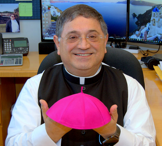 Bishop-elect Enrique Delgado shows the zuchetto, the skullcap, given to him by Archbishop Thomas Wenski after announcing his appointment as auxiliary  bishop of the archdiocese. Father Delgado said he was to wear it until his formal ordination as bishop, scheduled for Dec. 7.