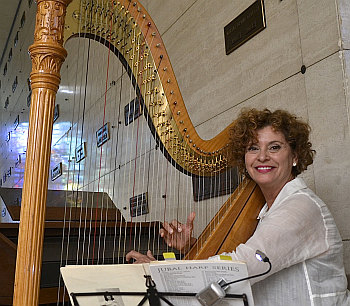 Harpist Trudy Faust provides music at the annual Christmas tree lighting ceremony at Our Lady of Mercy Cemetery in Doral.