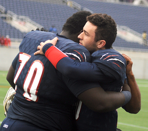 Chaminade-Madonna quarterback Daelen Menard, right, and guard Sebastian Sainterling celebrate the Lions' 31-28 victory over the West Palm Beach Oxbridge Academy ThunderWolves at the Class 3A FHSAA Football Final at Camping World Stadium in Orlando. Menard completed 5 of 9 passes for 144 yards and two touchdowns to help the Lions win their third state championship in school history