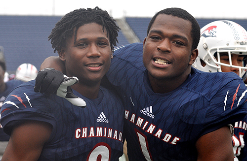 Chaminade-Madonna defenders Te'Cory Couch, left, and Keontra Smith celebrate a Lions touchdown in the second half of Chaminade-Madonna's 31-28 victory over the West Palm Beach Oxbridge Academy ThunderWolves at the Class 3A FHSAA Football Final.