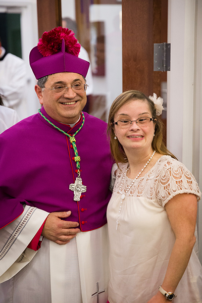 El Obispo Electo Enrique Delgado, párroco de la parroquia St. Katharine Drexel, en Weston, posa para una foto con una feligresa después de las vísperas solemnes, en la víspera de su ordenación como el nuevo Obispo Auxiliar de la Arquidiócesis de Miami.