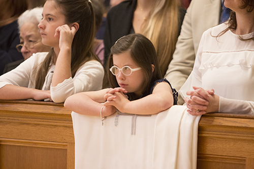 Mia Rodicio, 9, niece of Deacon Sergio Rodicio, watches intently during the Litany of the Saints.