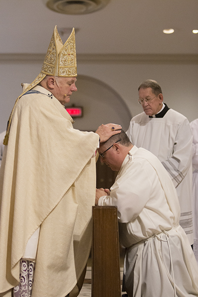 Archbishop Thomas Wenski ordains William Bertot of Gesu Church to the permanent deaconate.