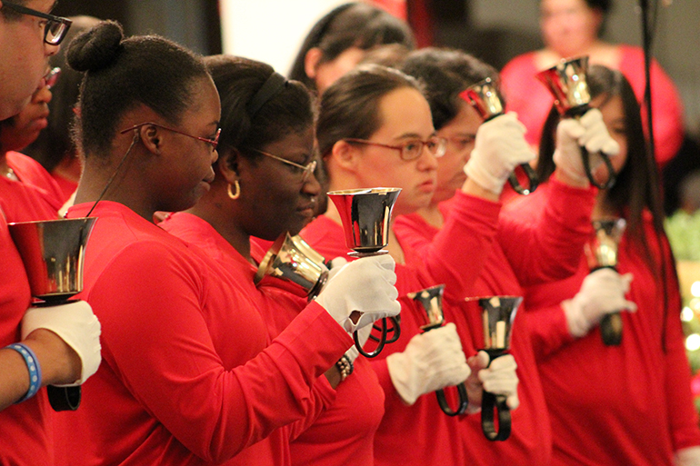 Hand bell choir members perform during the Making Miracles Happen Christmas concert at the Marian Center.