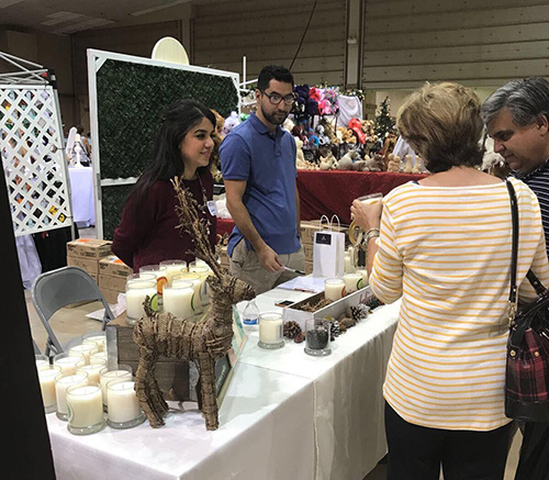 Vanessa Ruiz and Roger Ramirez sell Soy Luz candles at a recent event.