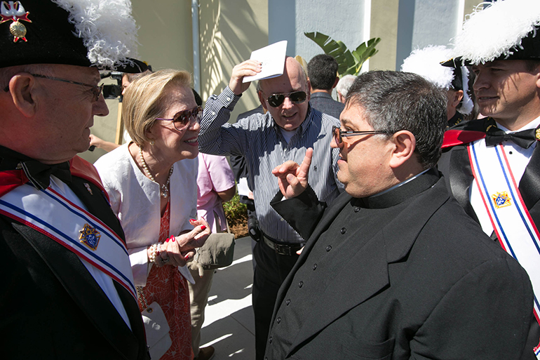 Father Enrique Delgado, St. Katharine Drexel's pastor, speaks with parishioners after the dedication of the parish's first church building, Feb. 16, 2014.