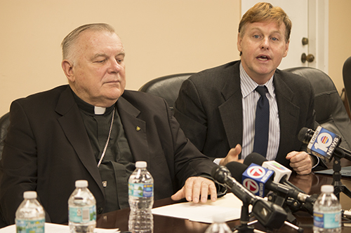 Randolph McGrorty, CEO of Catholic Legal Services of the Archdiocese of Miami, speaks to the press Nov. 22 regarding the termination of TPS for Haitians. Next to him is Archbishop Thomas Wenski.