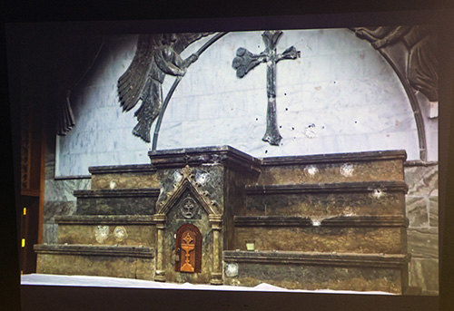 The bullet-ridden sanctuary of a Mosul church is shown during a slide presentation by Father Benedict Kiely, who spoke Dec. 11, 2017 at St. Agnes Church, Key Biscayne, about the persecution of Christians in the Middle East.