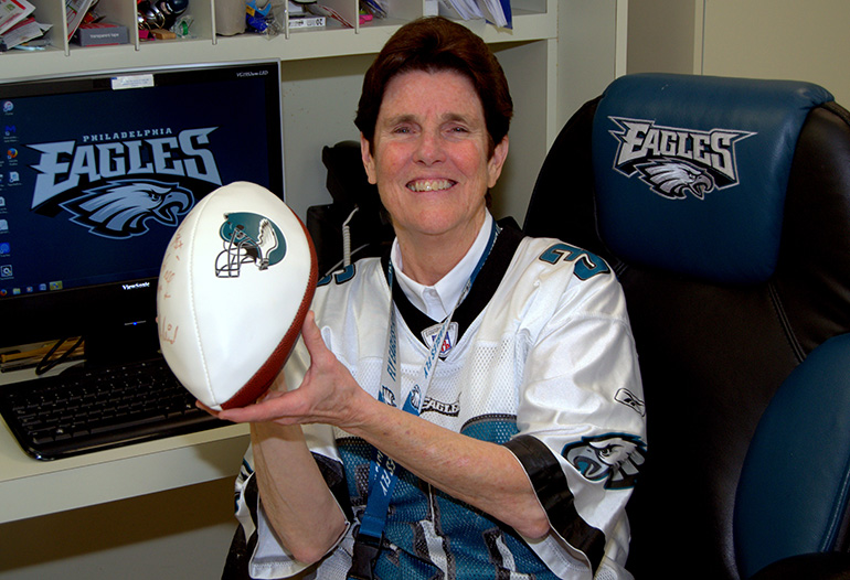 Sister Margaret Fagan shows off some of her swag for the Philadelphia Eagles: her jersey, an office chair and a computer wallpaper with the team logo, and a football autographed by former head coach Andy Reid. Sister Margaret is principal of Epiphany School in Miami.