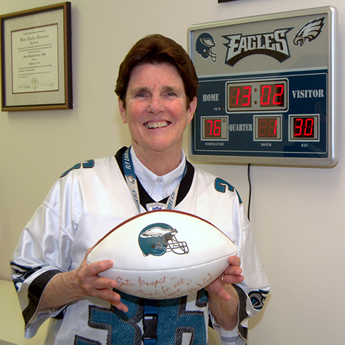Sister Margaret Fagan shows off a bit of her swag for the Philadelphia Eagles: her jersey, a miniature scoreboard, and a football autographed by former head coach Andy Reid.
