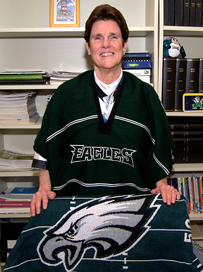 Sister Margaret Fagan shows off a poncho and blanket for the Philadelphia Eagles in her office at Epiphany School, Miami.