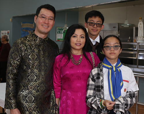 Khoa Mguyem poses with his family at the reception that followed the Migration Mass: wife Doan, son Kenneth and daughter Lindsey.