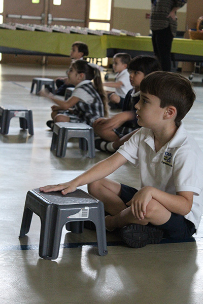 Students tap along to the beat during NeuroNet Learning morning exercises.