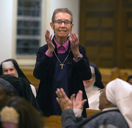 Sister Kathleenjoy Cooper, marking 60 years in religious life, acknowledges applause from the congregation during the annual celebration of the World Day of Consecrated Life. The Mass took place Jan. 20 at St. Mary Cathedral.