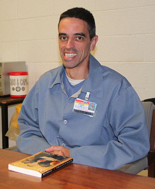 Earl J. Hinson sits for an interview at Martin Correctional Institution. With him is his Magnificat, which he carries with him most of the day.