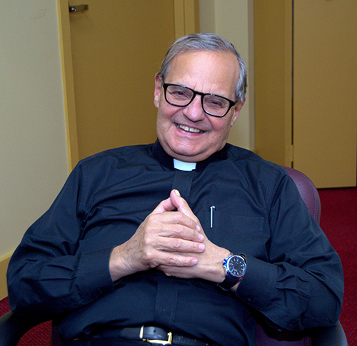Msgr. Franklyn M. Casale sits in his office at St. Thomas University, Miami Gardens. Behind him is a private entrance he never uses, preferring to remain open and visible to the university community. He's planning to retire this spring after a quarter-century as university president.
