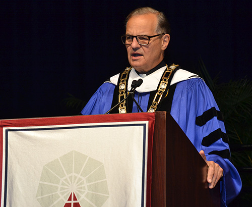 Msgr. Franklyn M. Casale addresses graduating students at the Dec. 16 commencement at St. Thomas University, Miami Gardens. He's planning to retire this spring after a quarter-century as university president.