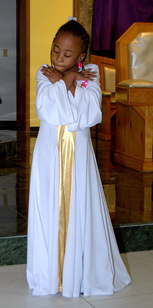 A member of the Mbofro Ne Nyame Dancers takes part in the black Catholic revival at St. Helen Church, Lauderdale Lakes.