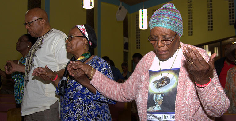 Worshipers pray Hail Marys during the black Catholic revival at St. Helen Church, Lauderdale Lakes.