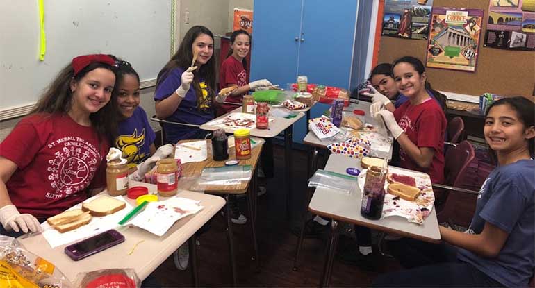 Students at St. Michael School in Miami engage in a sandwich-making marathon to aid the homeless at the start of Catholic Schools Week 2018.