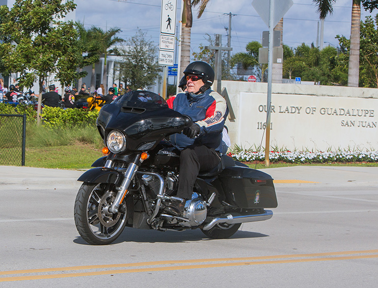 Archbishop Thomas Wenski sets out on his annual ride to raise funds for Catholic Charities' St. Luke's Center, a rehabilitation facility for those addicted to drugs and alcohol. The ride began with morning Mass at Our Lady of Guadalupe Church, Doral, and ended at Peterson's Harley-Davidson in Northwest Dade, with dozens of fellow bikers taking part.