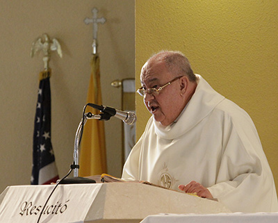 Father Fabio Arango, who lived with Bishop Agustin Roman at the Shrine of Our Lady of Charity for a couple of years, is seen here delivering the homily at the noon Mass the day after the bishop's death in 2012.