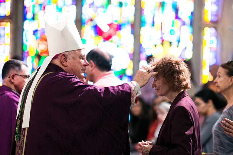 Archbishop Thomas Wenski imposes ashes on the faithful during Ash Wednesday Mass Feb. 14 at St. Anthony Church, Fort Lauderdale.