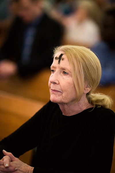 A parishioner prays after being marked with ashes during Ash Wednesday Mass Feb. 14 at St. Anthony Church, Fort Lauderdale. Archbishop Thomas Wenski presided at the Mass.