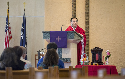 Father Thomas Liang, visiting priest from Shanxi Province in China, preaches the homily during the Chinese New Year Mass and Ancestral Veneration at St. Jerome Church in Fort Lauderdale. The Mass was celebrated in Chinese.