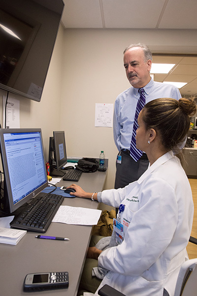 Dr. Kenneth Homer, standing, an internal medicine physician and medical director of Holy Cross Physician Partners in Fort Lauderdale, speaks with interns about Holy Cross Hospital’s Sexual Trafficking and Exploitation Program (STEP) linking medical staff with community resources toward a holistic response to human trafficking in South Florida.