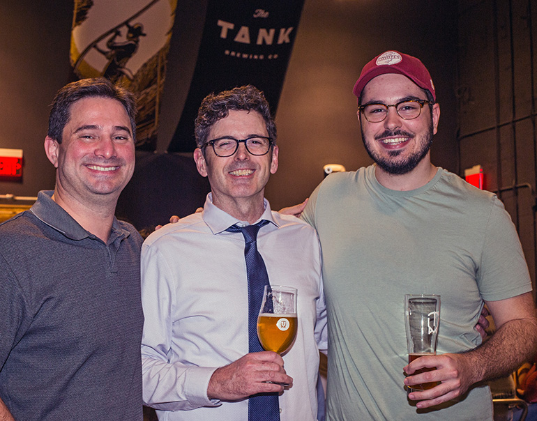 Catholic young adults, from left, Enrique Fiallos, Thomas McGregor and Don Uhlmann enjoy a brew during a Theology on Tap session at The Tank Brewing Company in Doral.