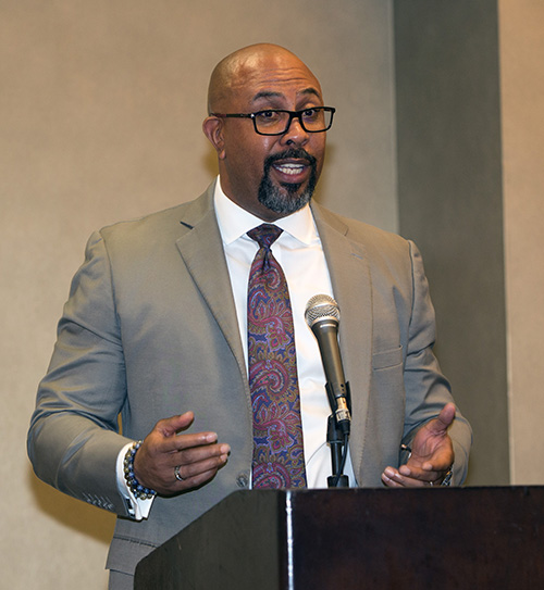 Richard Jean, principal of Archbishop Edward A. McCarthy High School, addresses members of the Miami Archdiocesan Council of Catholic Women and supporters at their annual scholarship luncheon.