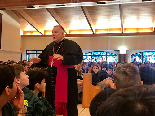 Archbishop Thomas Wenski speaks to sixth graders gathered at St. Gregory Church, Plantation, for the first of three Focus 11 vocations rallies Feb. 27.