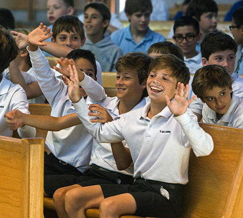 St. Agnes School sixth graders gyrate and sing "Yes, Lord, Yes, Lord, Yes, yes Lord," to the song, "Trading My Sorrows," during the Focus 11 vocations rally March 1 at St. Agatha Church, Miami.
