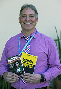 Frank Mercadante, one of several keynote speakers at the Archdiocese of Miami Youth Ministry Summit, holds books which he authored, "Engaging A New Generation" and "Positively Dangerous."