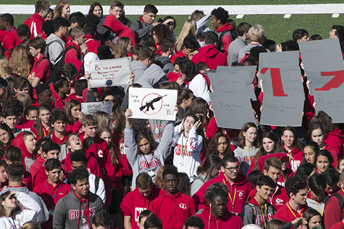 Cardinal Gibbons High School students hold up signs with the number 17 and the names of the Parkland shooting victims, as well as a plea to ban assault rifles, while forming a heart on the 50-yard line of their football field March 14. Most of the Gibbons student body took part in a nationwide memorial for the 17 victims of the shooting at Marjory Stoneman Douglas High School in Parkland a month before.