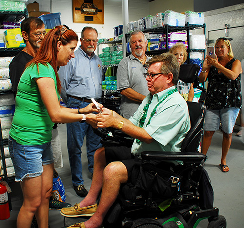 Tom Callahan, executive director of the Star of the Sea Foundation and SOS Outreach Mission, receives a plaque recognizing his tireless dedication to the mission, an outreach of the Basilica of St. Mary Star of the Sea in Key West.