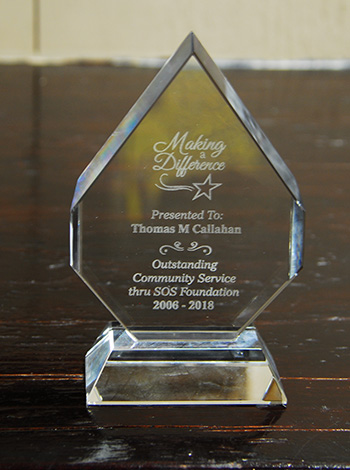 Tom Callahan, executive director of the Star of the Sea Foundation and SOS Outreach Mission, received this plaque recognizing his tireless dedication to the mission, an outreach of the Basilica of St. Mary Star of the Sea in Key West.