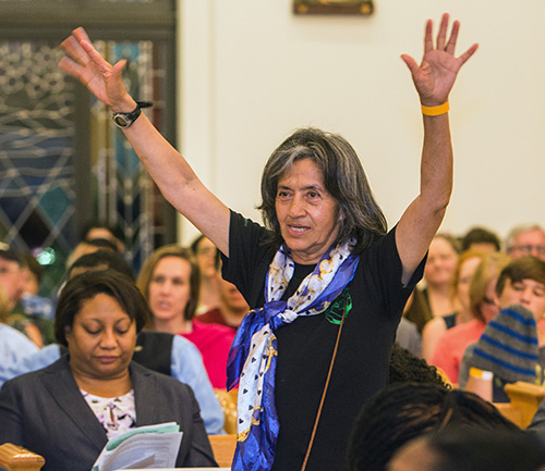 Maria Vasquez raises her hands as Miami City Commissioner Ken Russell gives a positive answer on affordable housing during PACT's annual Nehemiah Action Assembly, March 19, 2018 at Notre Dame d'Haiti Church, Miami.