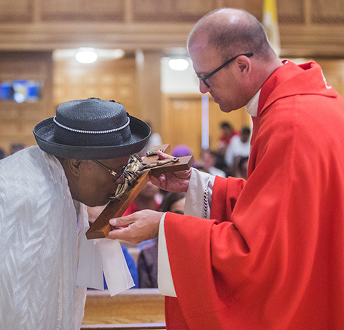 March 30, 2018
MARLENE QUARONI | FC

Father Christopher Marino, rector of St. Mary Cathedral, holds the cross as Marie Fleurimon kisses it.

Archbishop Thomas Wenski officiates at Good Friday service, the Liturgy of the Lord's Passion.