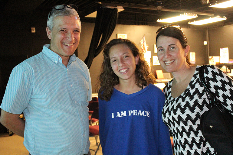 Dressed for peace: Immaculata-La Salle junior Valentina Alaimo wears a sweater supporting peace to Carl Wilkens's lecture about Rwanda. With her is her mom, Antonella Vaccaro.