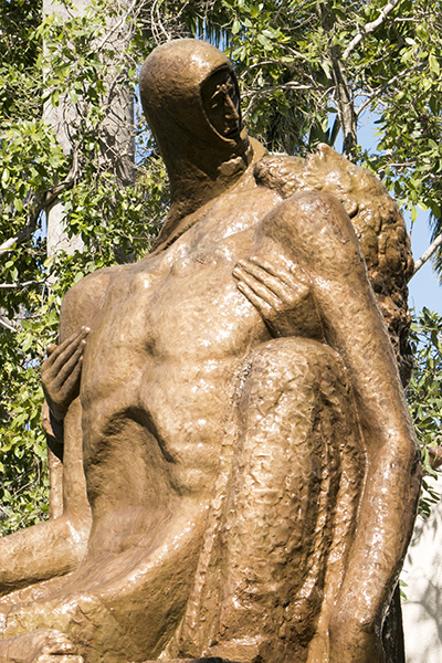 The Pieta glistens in the afternoon sun after being sprayed with water and having most of the patina rubbed onto it, March 23, 2018.