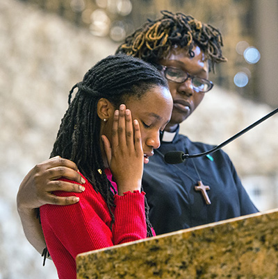 Rev. Andrea Byer-Thomas, of Village United Methodist Church in North Lauderdale, comforts her daughter, Arleigha Byer, 15, as she testifies at BOLD Justice's 2018 Nehemiah Action assembly about her friend Gina Montalto, who belonged to the same Girl Scout troop and was killed at Marjorie Stoneman Douglas High School.