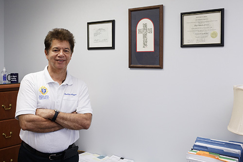 In his office in Wilton Manors, Peter Routsis-Arroyo, previously head of Catholic Charities in the Diocese of Venice, has begun his role of serving as CEO of Catholic Charities in the Archdiocese of Miami. He has been traveling to Charities sites throughout the archdiocese.