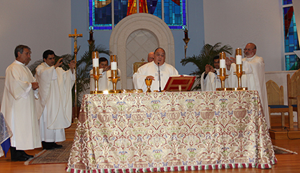 Father Enrique Estrada, pastor of Our lady of Divine Providence Church in Sweetwater, concelebrates the Mass for peace in Nicaragua along with other Nicaraguan-born priests who serve in the Archdiocese of Miami.