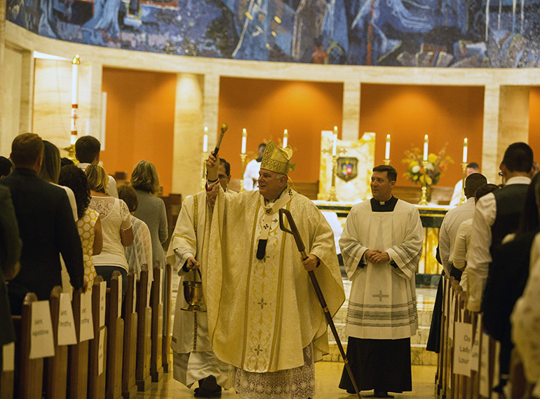 Archbishop Thomas Wenski blesses the congregation at the start of one of two Rite of Reception ceremonies April 29 at St. Mary Cathedral, welcoming new Catholics into full communion with the Church.