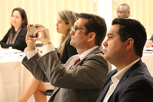 Daniel Biggs III, LUTCF, and a member of the Planned Giving Advisory Council for the Archdiocese of Miami Office of Development, takes notes via photos during Sally Mulhern's presentation on estate planning.