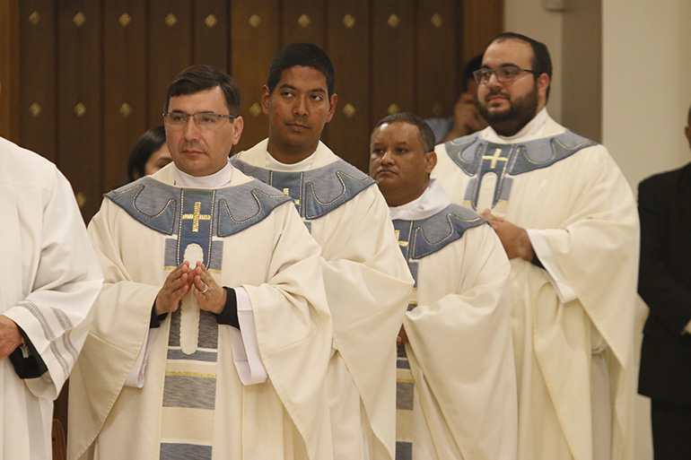 Newly ordained priests return to take their place in the sanctuary after having their hands anointed with oil of chrism. From left: Fathers Omar Ayubi, Juan Alberto Gomez, Gustavo Barros and Matthew Gomez.