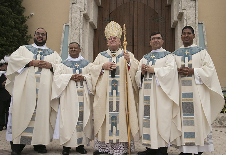 After the ceremony, Archbishop Thomas Wenski, center, poses with the newly ordained outside St. Mary Cathedral. From left: Father Matthew Gomez, Father Gustavo Barros, Father Omar Ayubi and Father Juan Alberto Gomez.