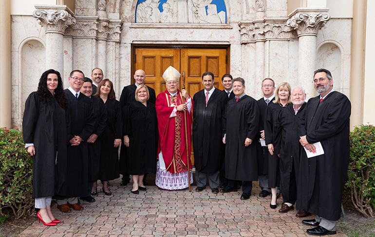 Miami Archbishop Thomas Wenski poses for a picture with local judges following the annual Red Mass of the St. Thomas More Society of South Florida, held at St. Anthony Church in Fort Lauderdale May 15.